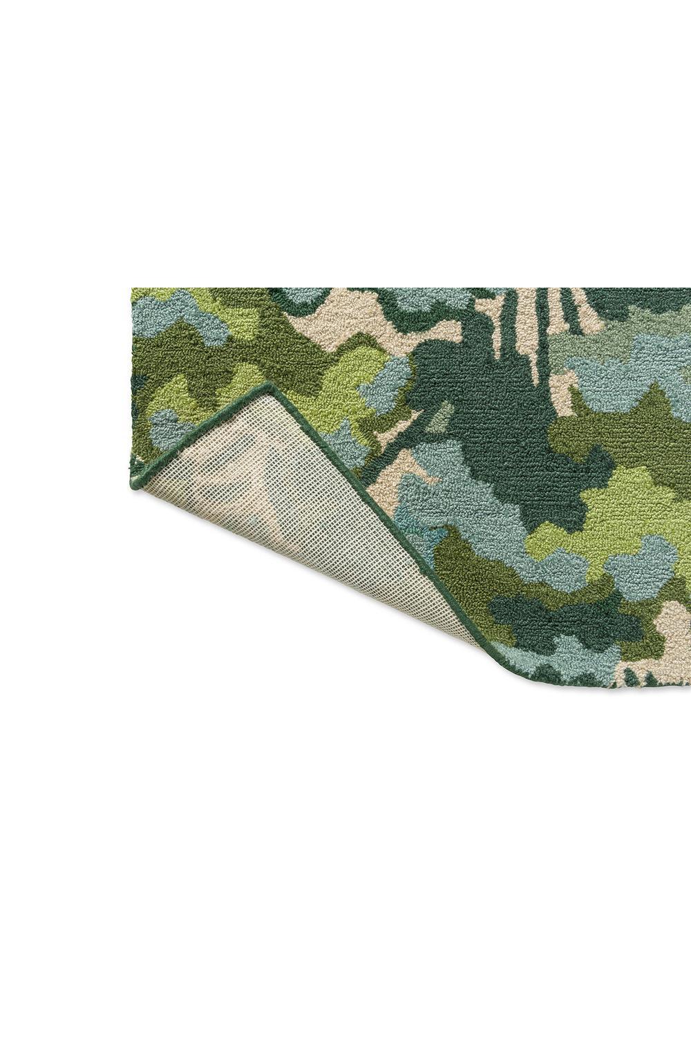 Harlequin Tree Tops Green Designer Outdoor Rug featuring leafy camouflage in emerald green, olive, sage, teal and beige on cream background, machine-woven polypropylene