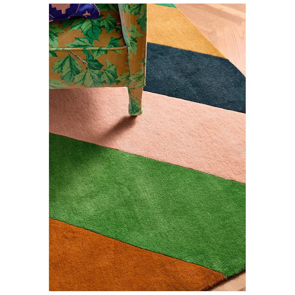Sophie Robinson x Harlequin Sherbet Stripe rug featuring bold emerald green, pink, peach, navy and orange stripes on cream background, hand-tufted wool