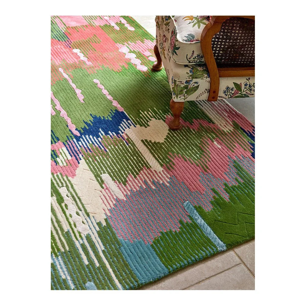 Sophie Robinson Wilderness rug by Harlequin featuring abstract geometric pattern in emerald green, peridot, pink, blue on cream background, hand-tufted wool