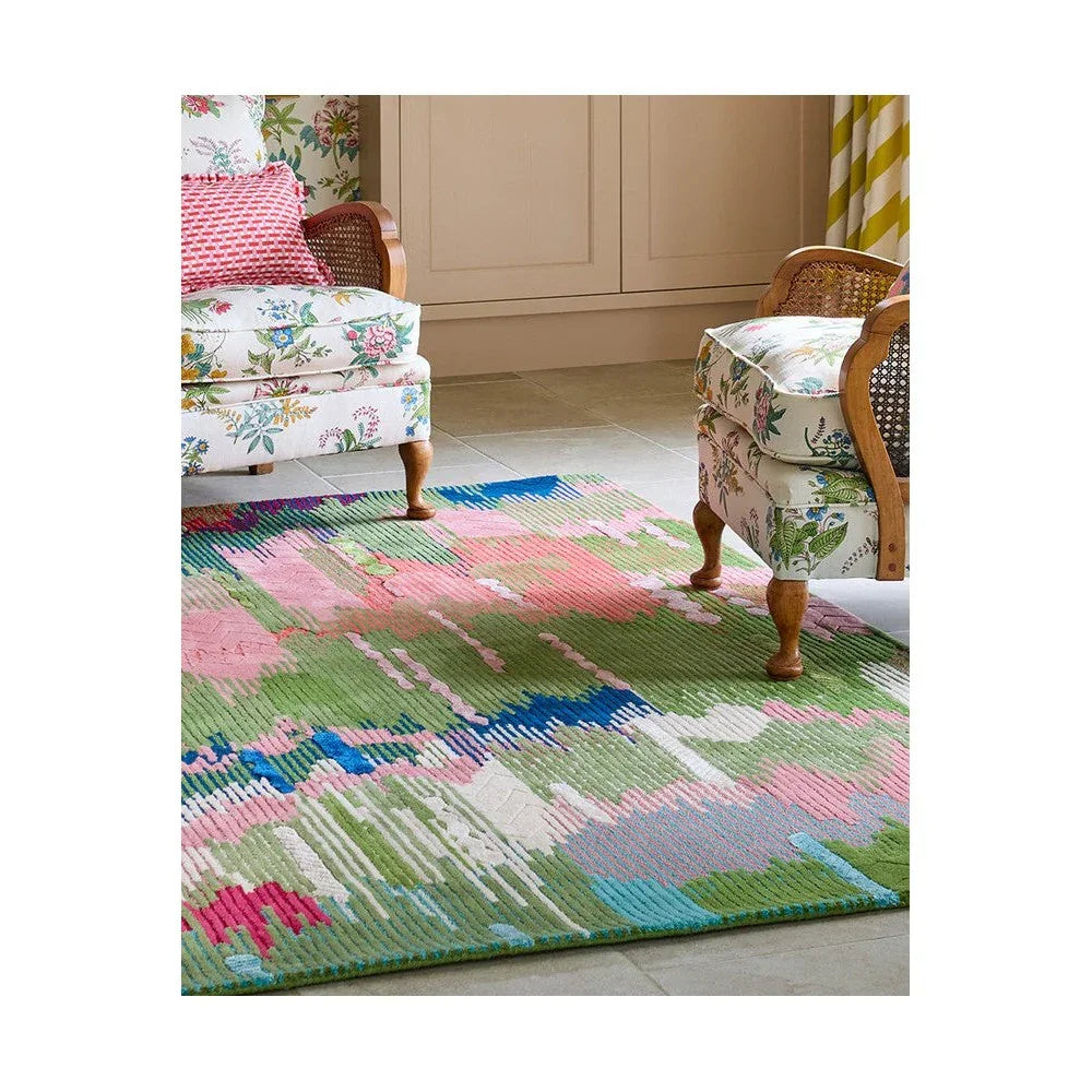 Sophie Robinson x Harlequin Wilderness rug featuring abstract botanical pattern in peridot, emerald, pink and blue on cream background, hand-tufted wool