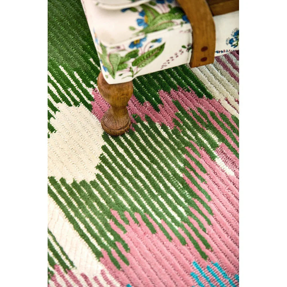 Sophie Robinson x Harlequin Wilderness rug featuring abstract brushstroke pattern in peridot green, emerald, pink on cream background, hand-tufted wool
