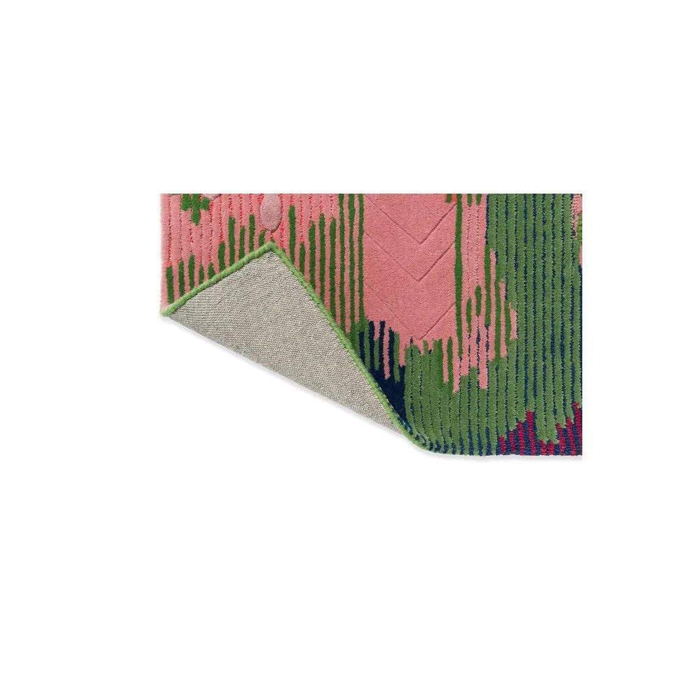 Sophie Robinson x Harlequin Wilderness rug featuring abstract botanical pattern in peridot, emerald, pink and navy on pink background, hand-tufted wool