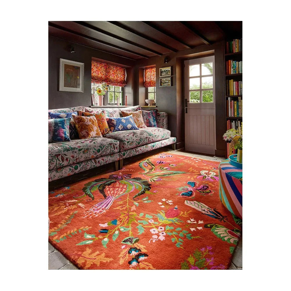 Sophie Robinson x Harlequin Wonderland Floral Rug in amber and lapis blue on orange background, hand-tufted wool