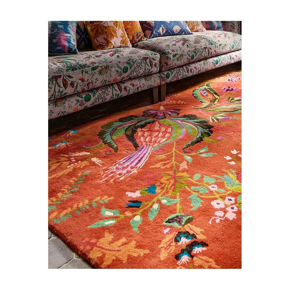 Sophie Robinson x Harlequin Wonderland Floral Amber/Lapis Designer Rug featuring vibrant floral pattern in amber, lapis blue, greens and pinks on orange background, hand-tufted wool