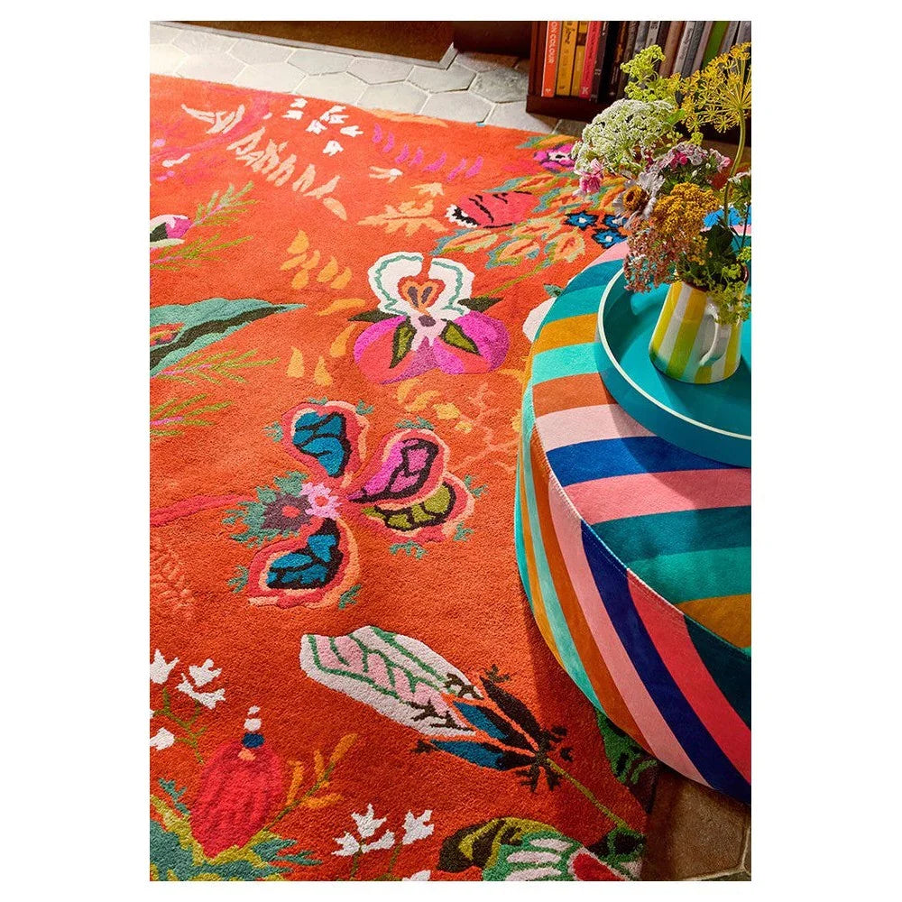 Sophie Robinson Harlequin Wonderland Floral rug featuring vibrant floral pattern in amber orange, turquoise, pink on orange background, hand-tufted wool