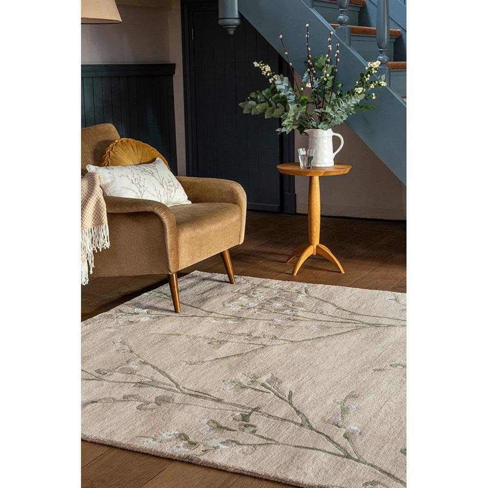 Laura Ashley Pussy Willow Hedgerow Green Designer Rug featuring botanical branch pattern in sage green, cream on beige background, hand-tufted wool
