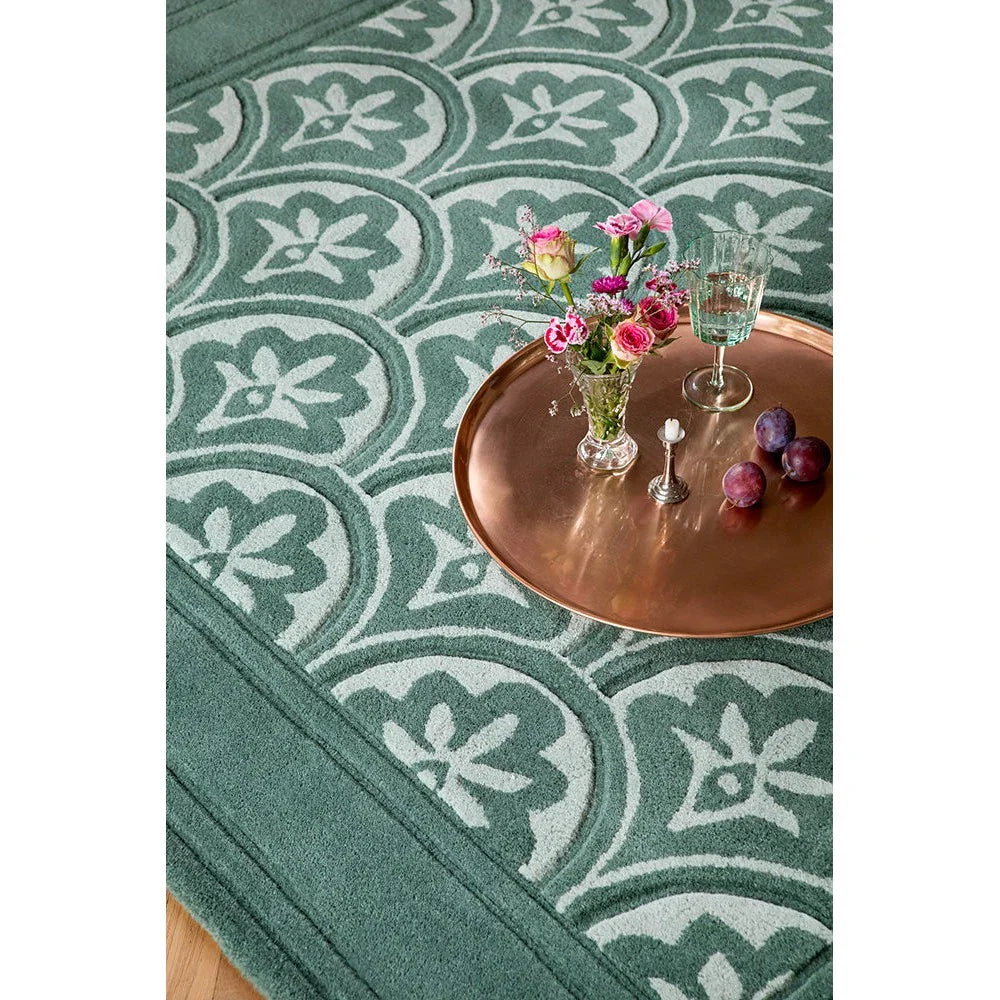 Laura Ashley Catarina Fern Designer Rug featuring botanical floral pattern in teal, sage and cream on teal background, machine-made wool blend