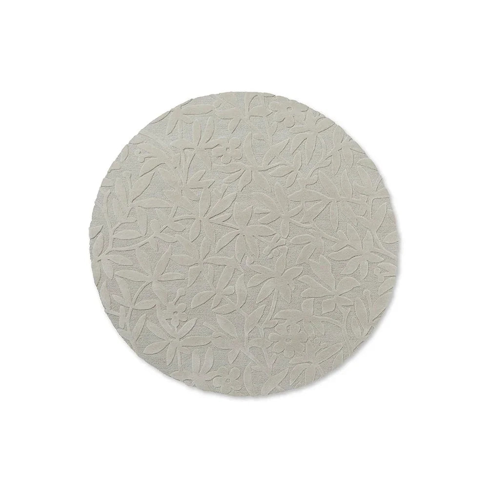 Laura Ashley Cleavers Round Rug featuring embossed floral pattern in ivory, cream and light beige on cream background; hand-tufted wool