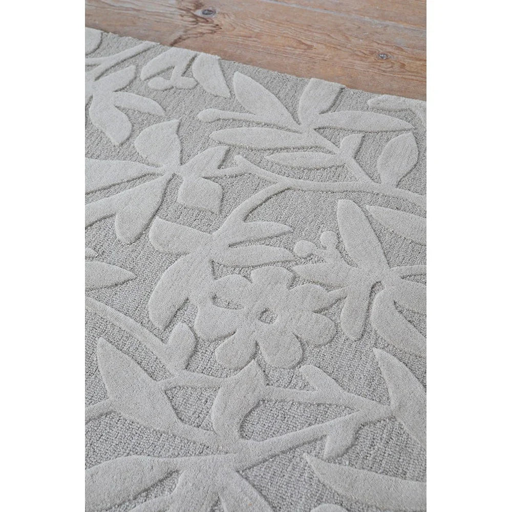 Laura Ashley Cleavers Natural Designer Rug featuring floral leaf pattern in soft cream and pale grey on light grey, machine-woven wool