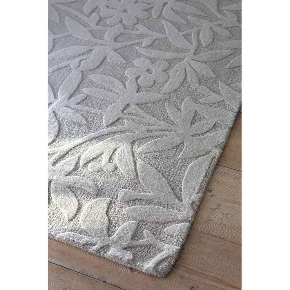 Laura Ashley Cleavers Natural Designer Rug featuring leafy botanical pattern in cream and ivory on beige background, hand-tufted wool