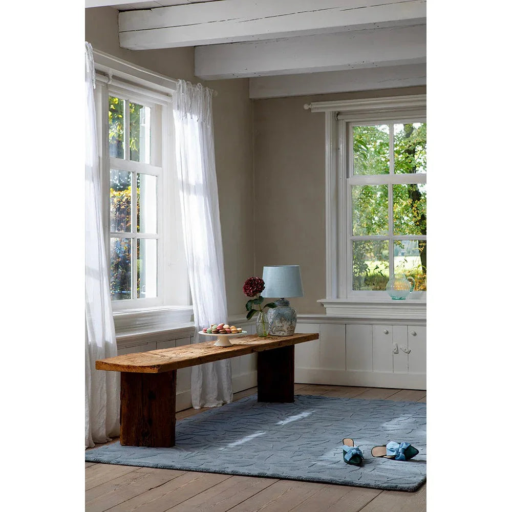 Laura Ashley Cleavers Seaspray Rug featuring wave pattern in powder blue, light blue and cream on beige, machine-loomed polypropylene
