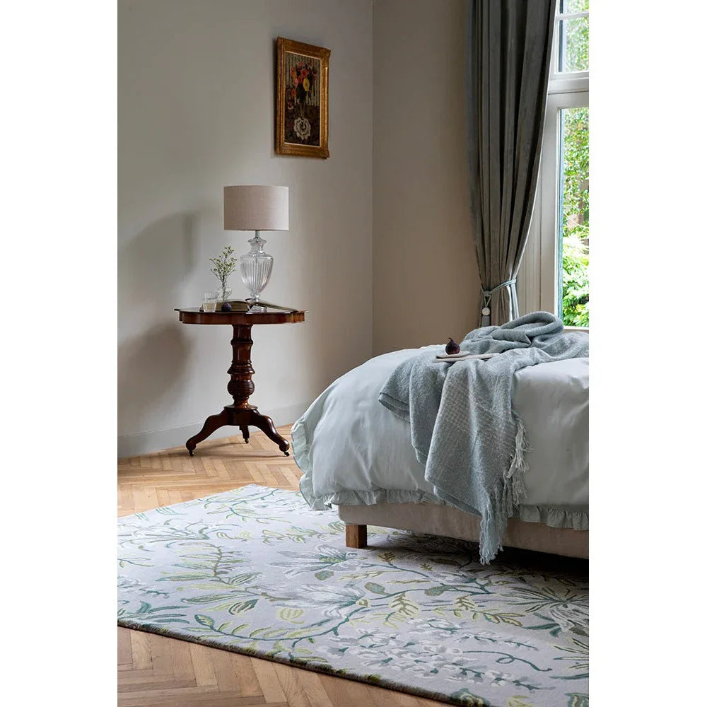 Laura Ashley Parterre Sage Designer Rug featuring botanical floral pattern in sage green, pale blue and ivory on cream background, machine-woven wool