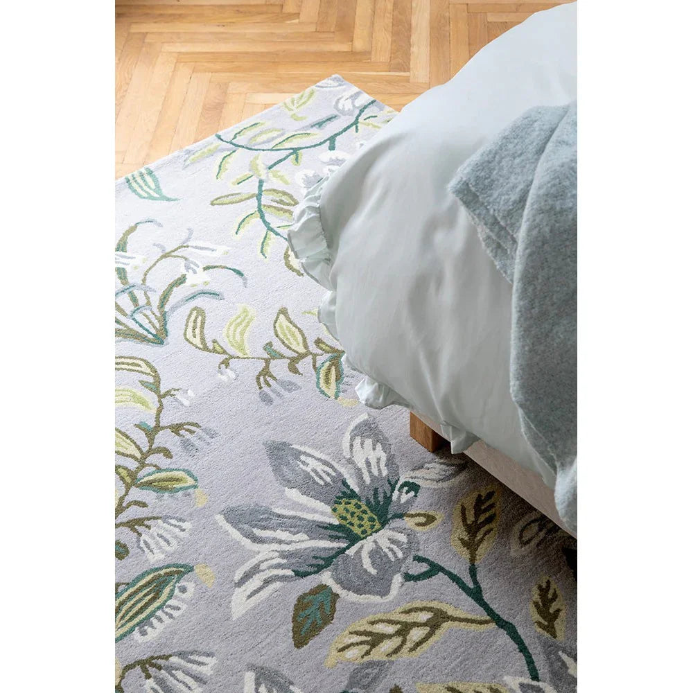 Laura Ashley Parterre Sage Designer Rug featuring botanical floral pattern in sage green, dusty blue, olive and cream on ivory background, hand-tufted wool