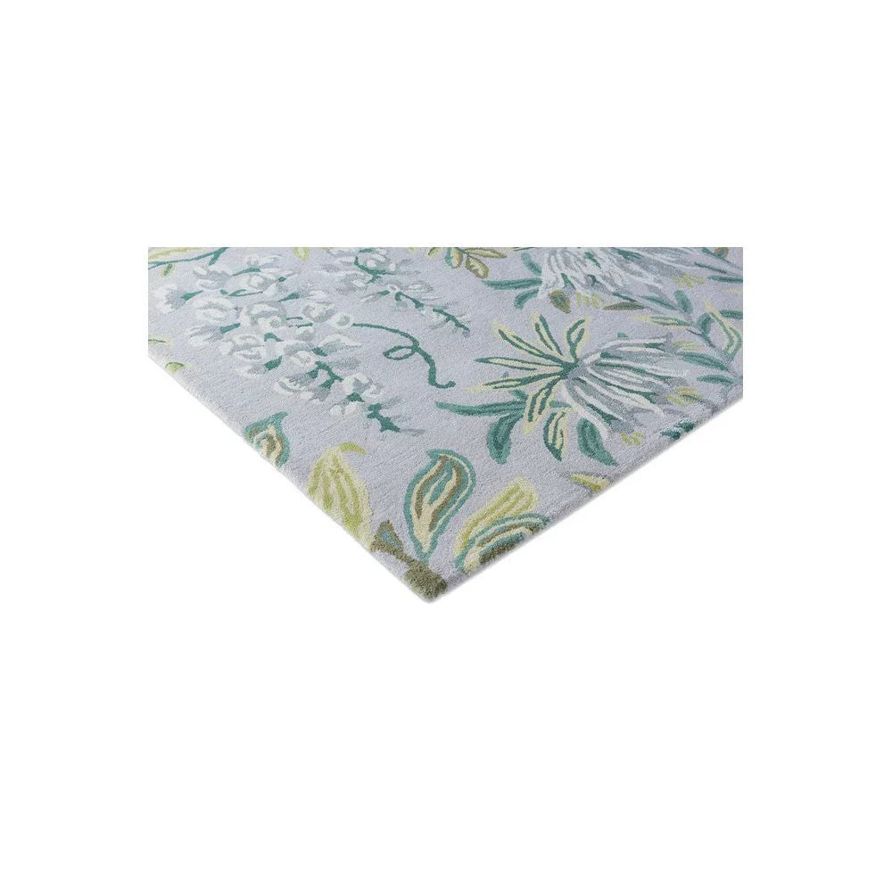Laura Ashley Parterre Sage Rug featuring botanical floral pattern in sage green, teal and mint on light blue background, hand-tufted wool