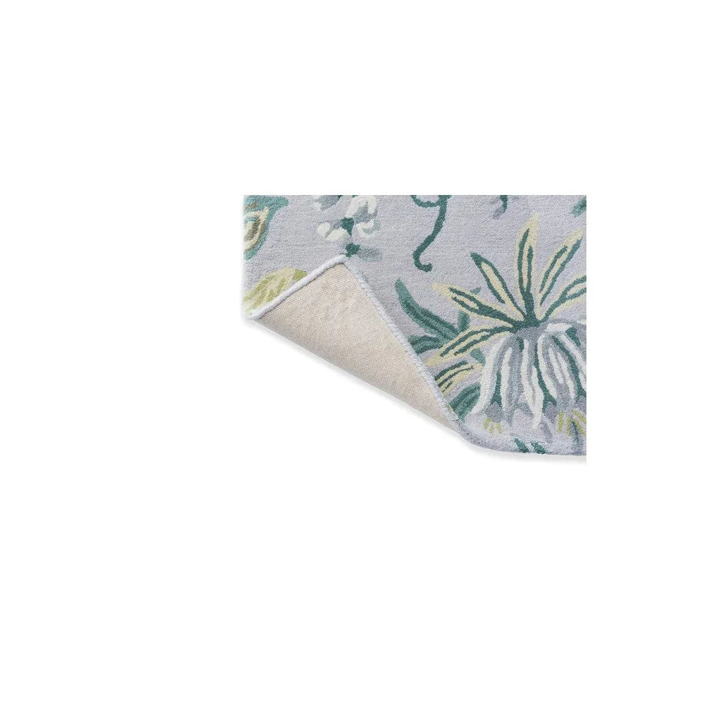 Laura Ashley Parterre Sage Designer Rug featuring botanical leaf pattern in sage green, teal, pale yellow on light grey background, hand-tufted wool