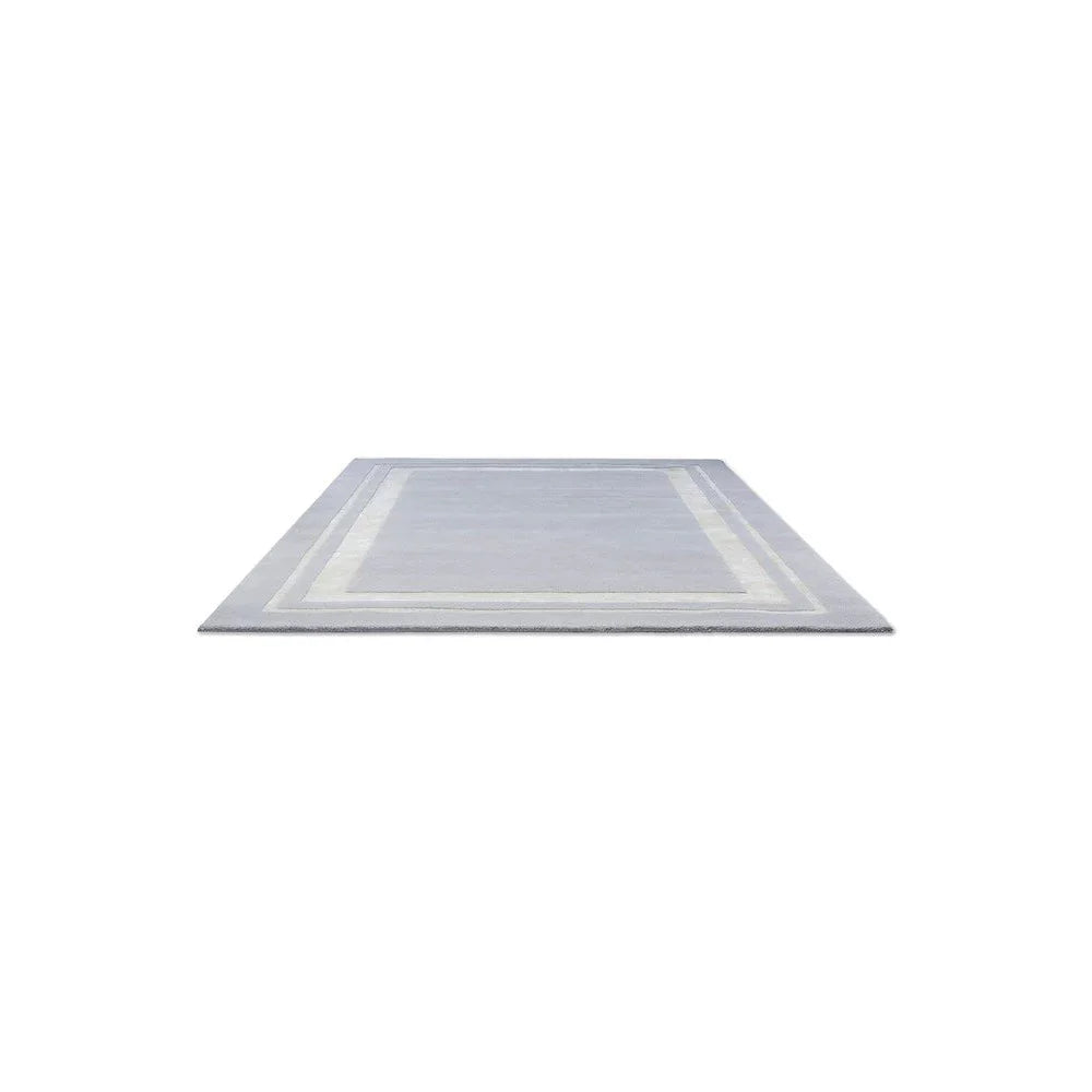 Laura Ashley Redbrook Silver Rug featuring a bordered geometric design in silvery grey and ivory on pale blue-grey, machine-made