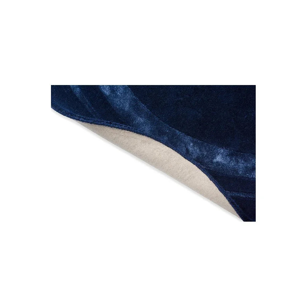 Laura Ashley Redbrook Midnight Designer Round Rug featuring solid velvet design in navy blue with beige underside on white background, hand-tufted wool