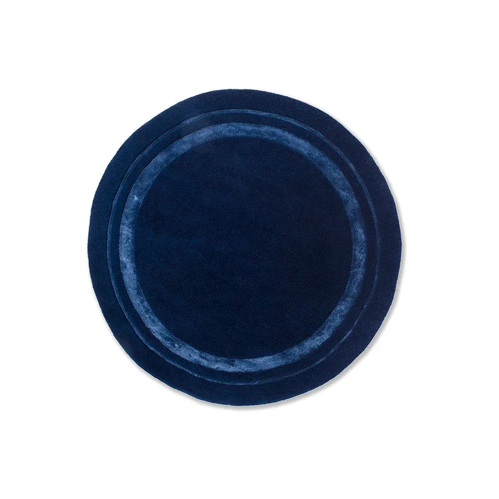 Laura Ashley Redbrook Midnight round rug featuring concentric ring design in navy velvet on deep blue background, hand-tufted wool