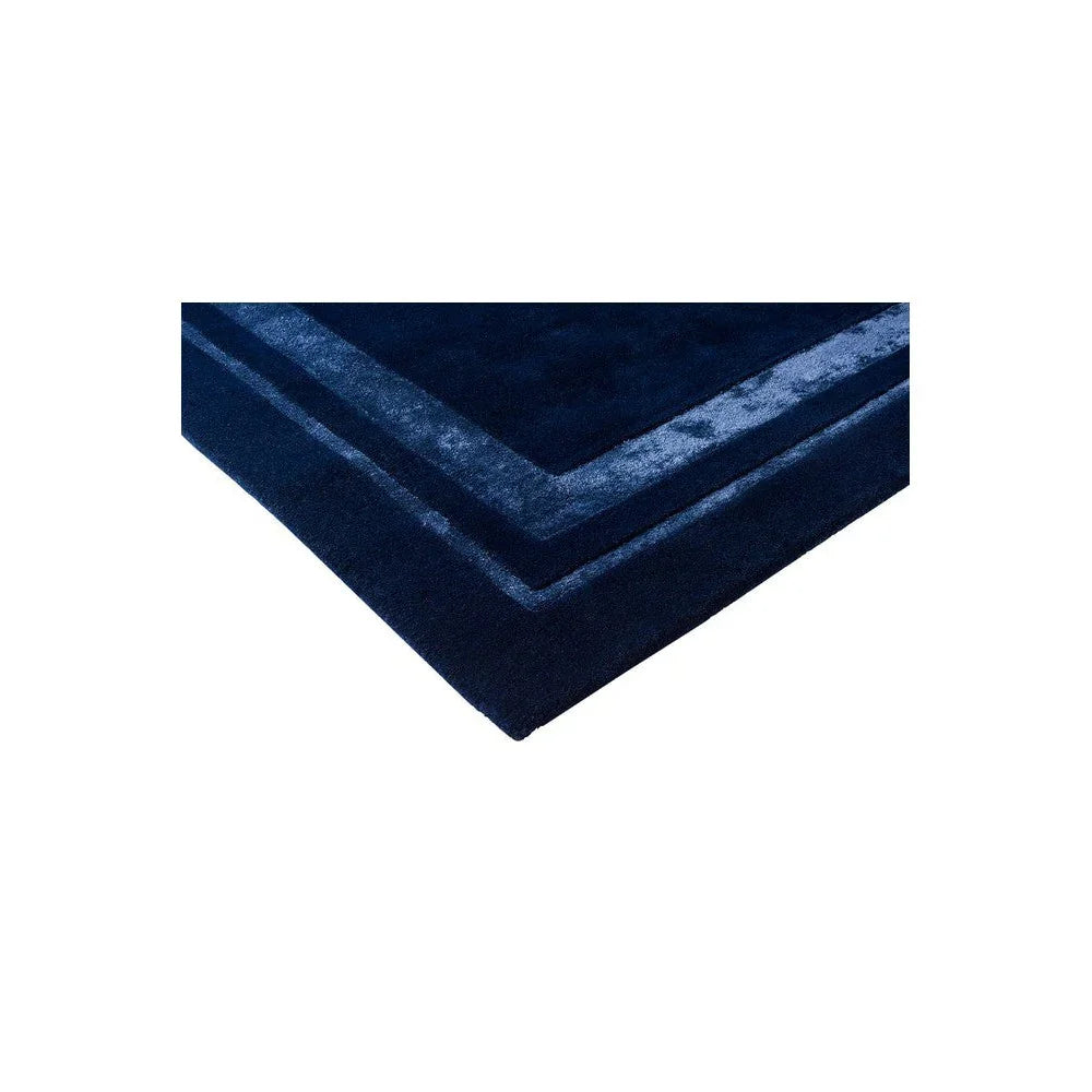 Laura Ashley Redbrook Midnight Rug featuring layered border pattern in navy blue and royal blue on white background, hand-tufted wool