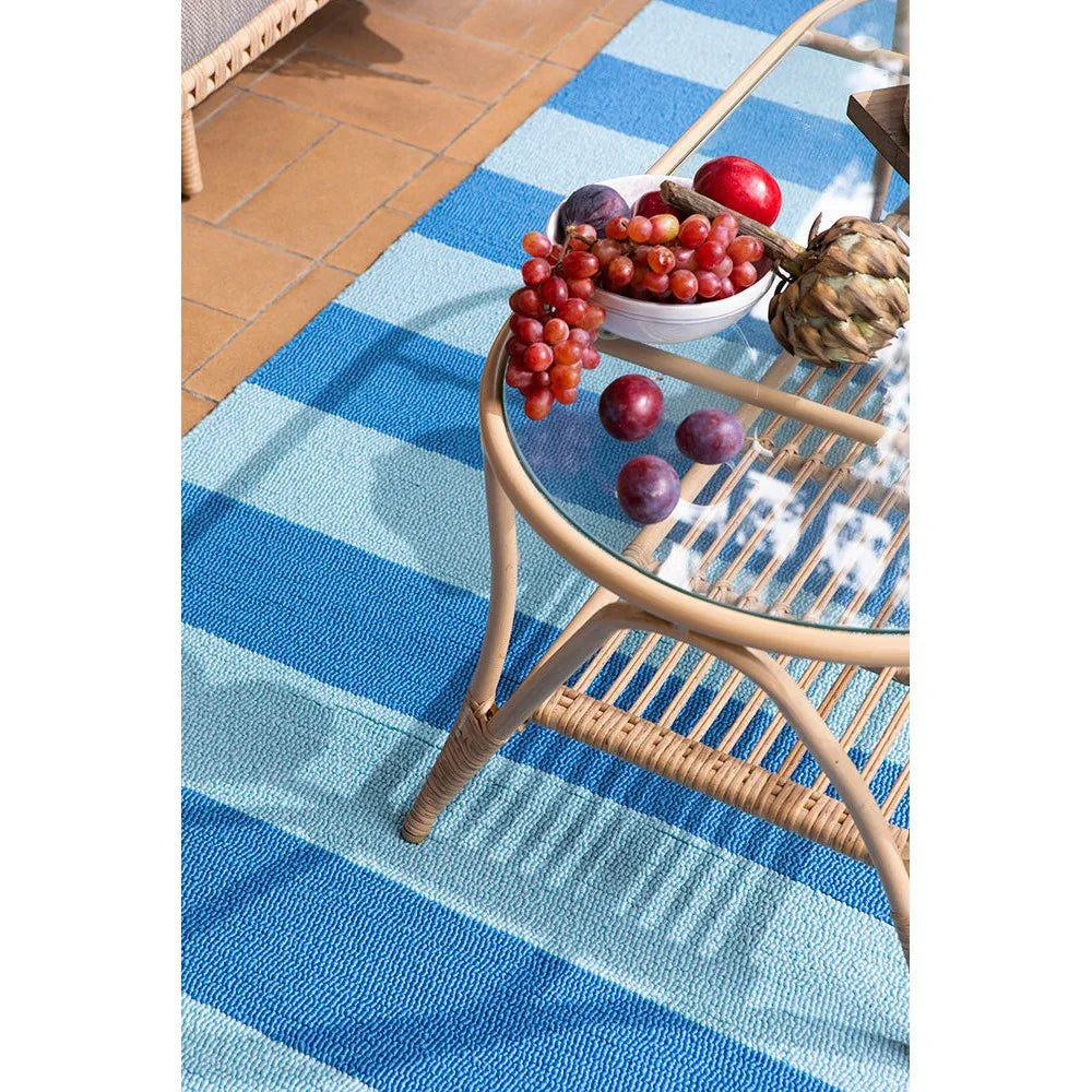 Laura Ashley Lille Sky Blue Outdoor Rug featuring striped pattern in sky blue, navy & turquoise on light blue background, power-loomed polypropylene