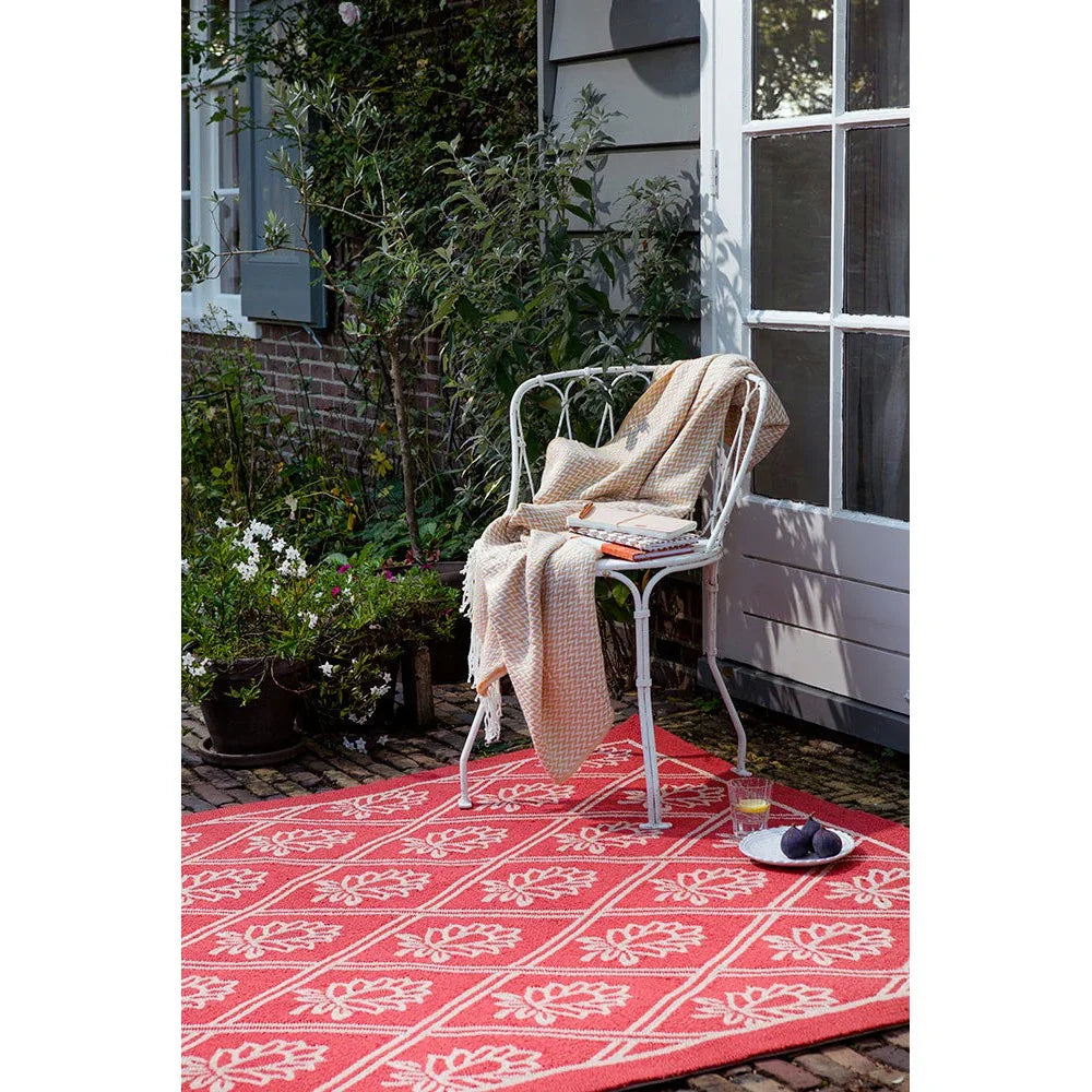 Laura Ashley Porchester Poppy Red Outdoor Rug featuring floral lattice pattern in poppy red, white on red background, machine-woven polypropylene