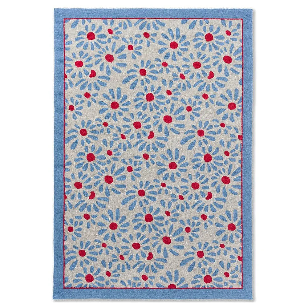 Laura Ashley Thorncliff Sky Blue Outdoor Rug featuring blue-petal daisies with red centers on beige, sky-blue border, machine-woven polypropylene