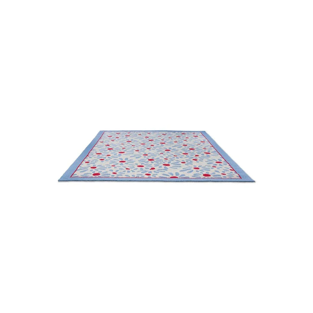 Laura Ashley Thorncliff Sky Blue Outdoor Rug featuring red dot and white leaf pattern on sky-blue field with blue border, machine-loomed polypropylene