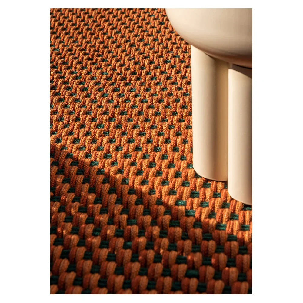 Brink & Campman Lace Tri-coloure Terra outdoor designer rug featuring a woven grid pattern in burnt orange with teal accents on terracotta background, power-loomed polypropylene