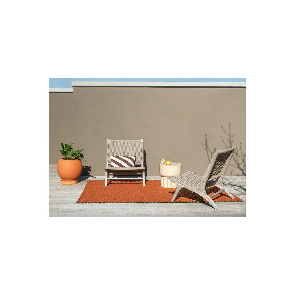 Brink & Campman Lace Tri-coloure Terra outdoor rug featuring woven textured pattern in terracotta, burnt orange and clay on light deck