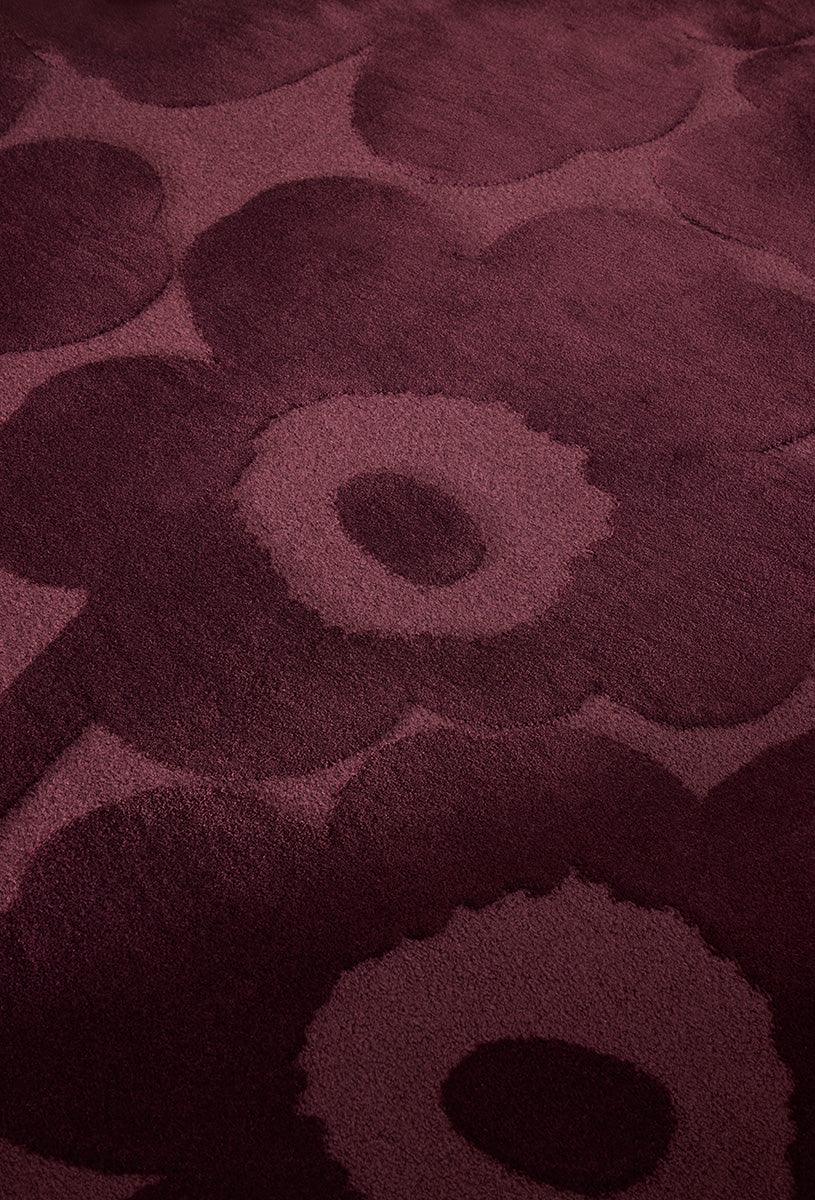 Marimekko Unikko Burgundy rug featuring floral poppy pattern in burgundy, wine red and dusty rose on deep burgundy background, machine-woven wool