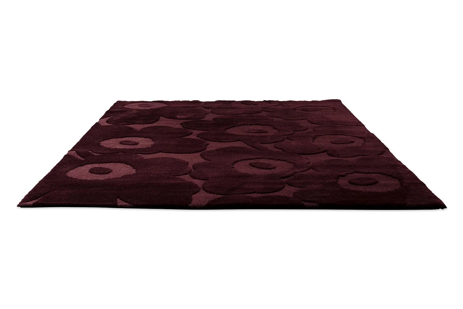 Marimekko Unikko Burgundy rug featuring motif in burgundy, wine and rose on a burgundy background, power-loomed wool