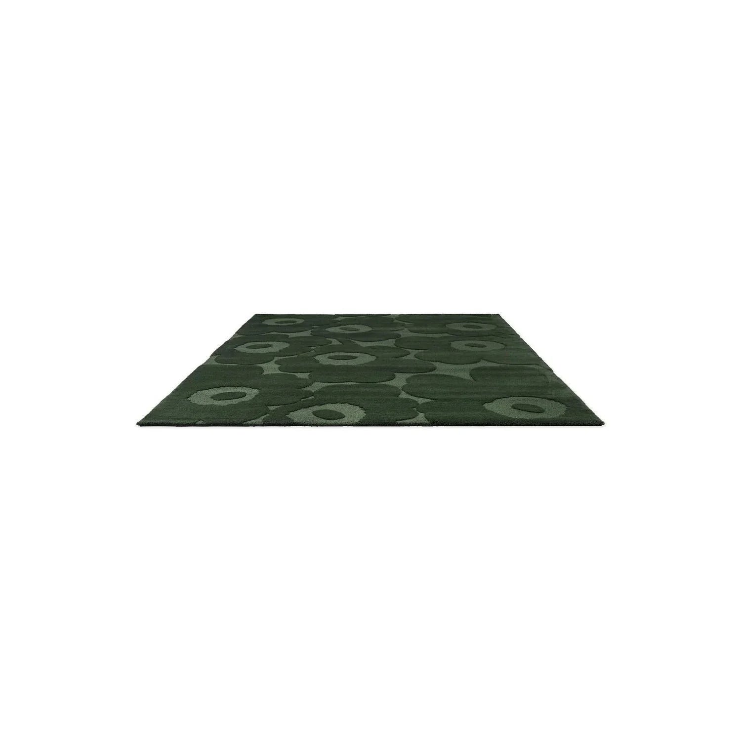 Marimekko Unikko Dark Green rug featuring circular ring pattern in emerald, olive and dark green on deep green background, hand-tufted wool