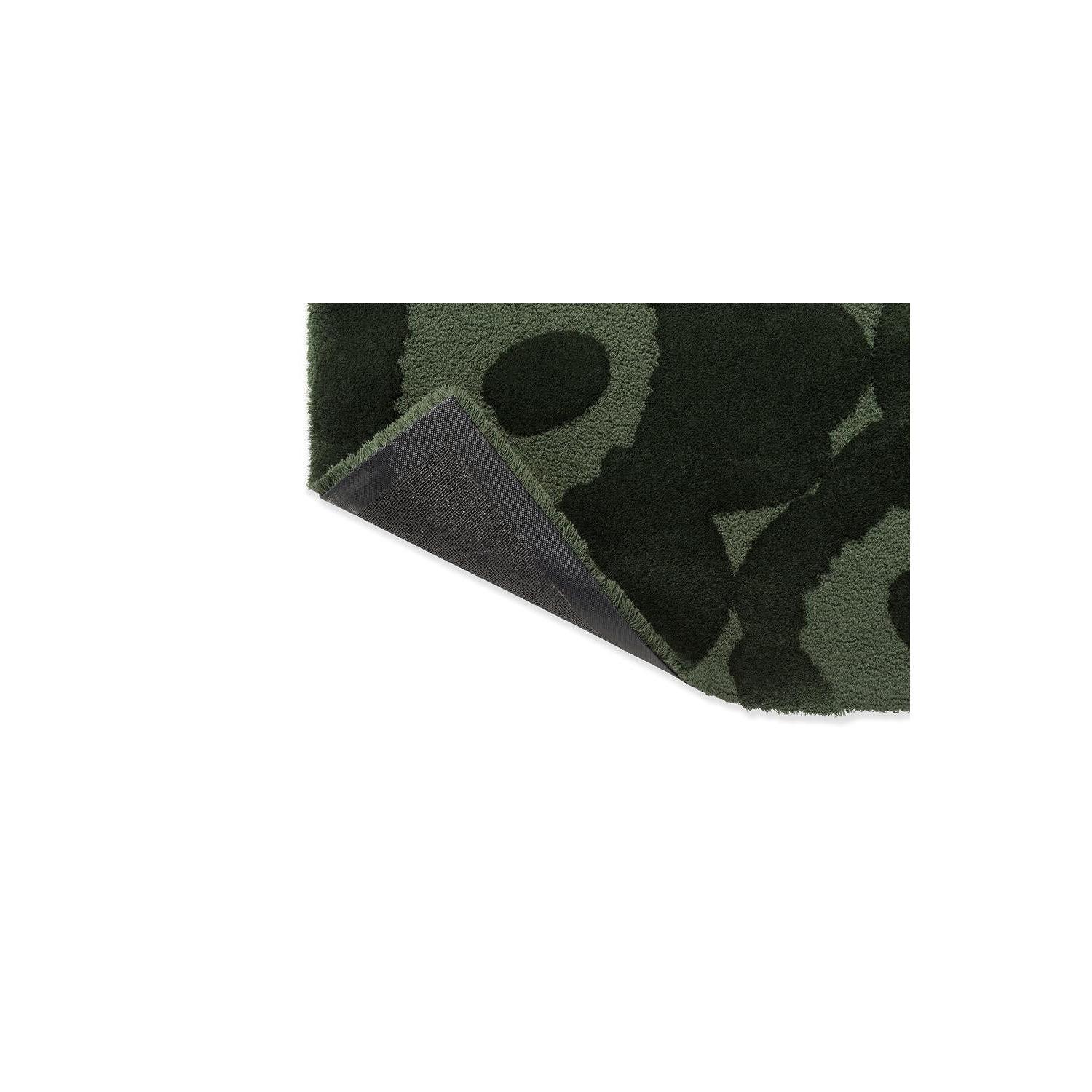 Marimekko Unikko Dark Green Rug featuring floral pattern in forest green, olive green and black on dark green background, hand-tufted wool