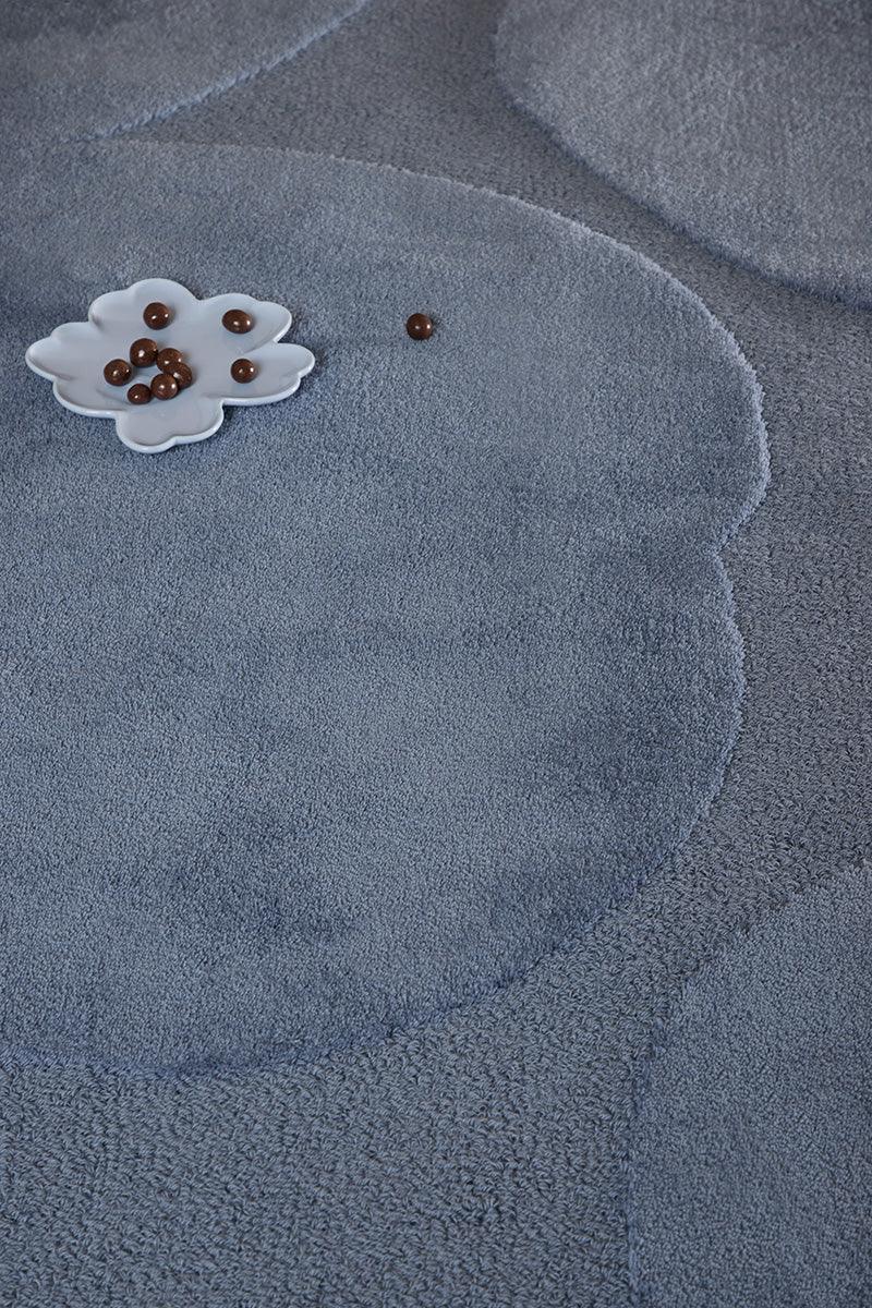 Marimekko Iso Unikko Dusty Blue rug featuring floral pattern in dusty blue and navy on blue background, tufted wool