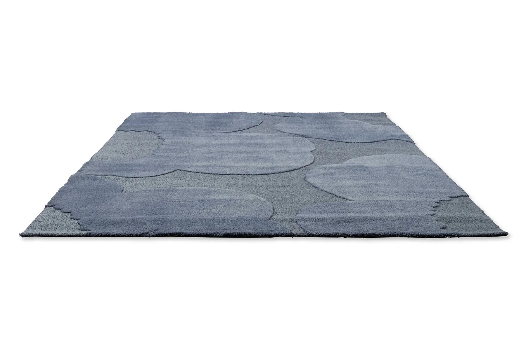 Marimekko Iso Unikko Dusty Blue Rug with patchwork in dusty blue, steel blue and navy on midblue, handtufted wool