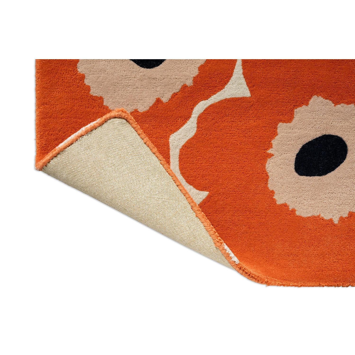 Marimekko Unikko orange red runner rug featuring floral pattern in orange, beige and black on orange background, tufted wool