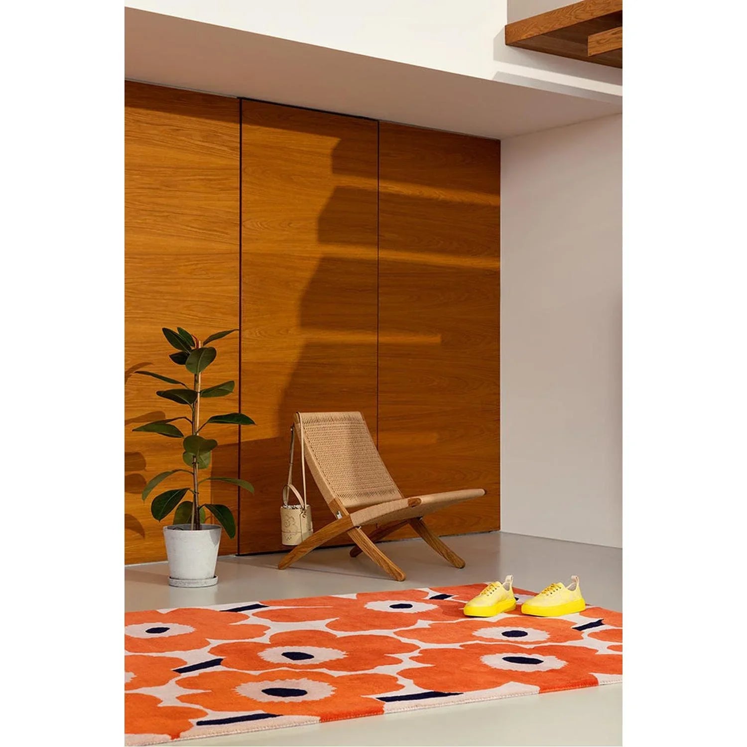 Marimekko Unikko Orange Red Designer Rug featuring bold floral pattern in orange, white and navy on light grey background, machine-made wool