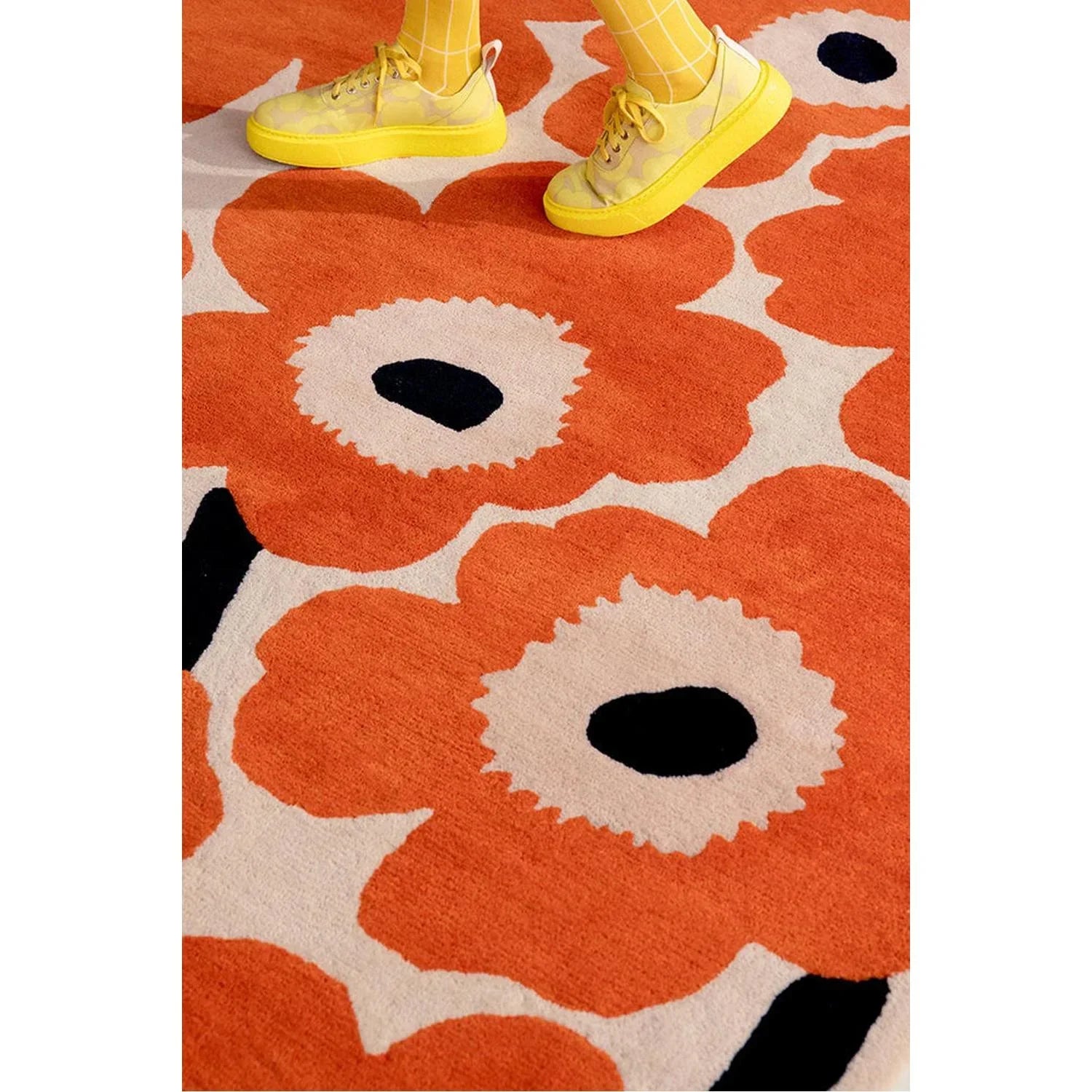 Marimekko Unikko Rug featuring bold floral poppy pattern in orange-red, cream and black on ivory background, hand-tufted wool