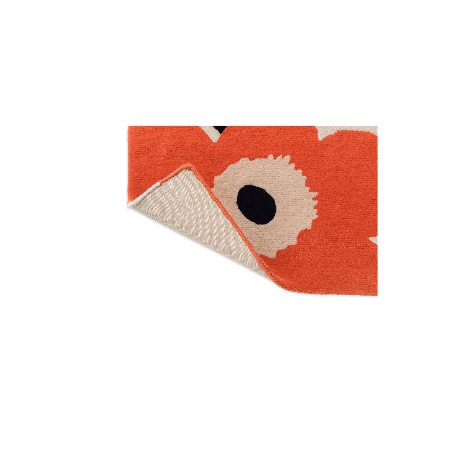 Marimekko Unikko Orange Red Rug featuring floral pattern in orange-red, cream and black on cream background, hand-tufted wool