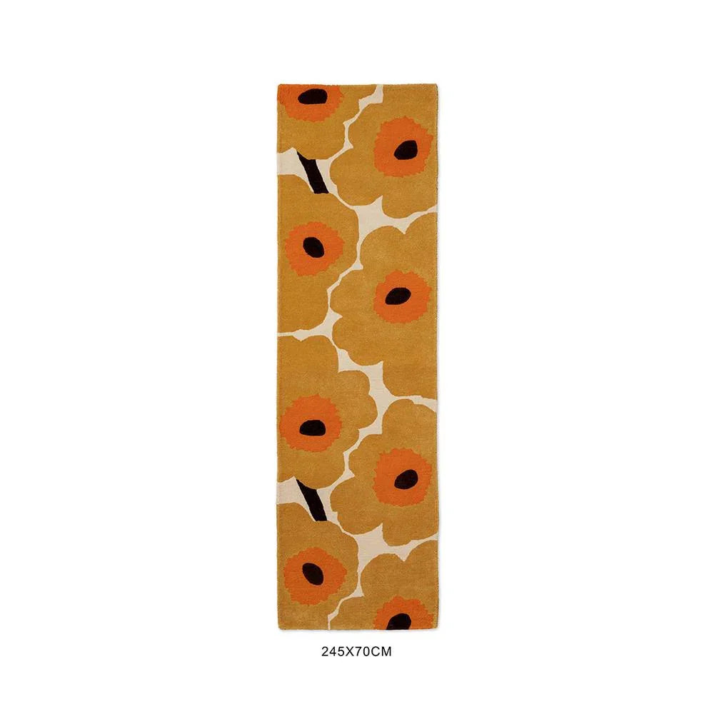 Marimekko Unikko Honey rug with floral poppy pattern in mustard, orange and black on cream background, hand-tufted wool