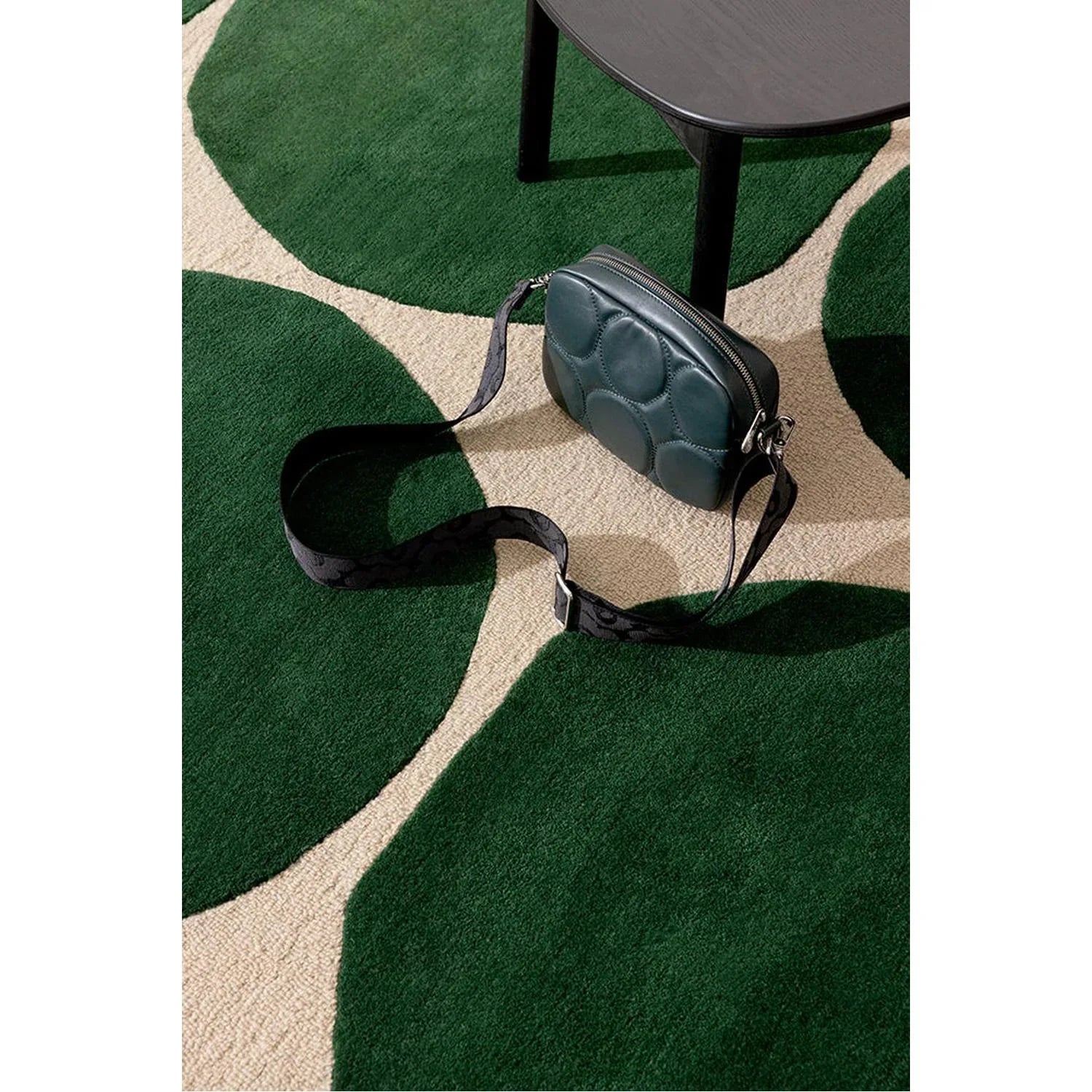 Marimekko Isot Kivet Green rug featuring large circular stone pattern in emerald, forest, sage greens on beige background, woven rug