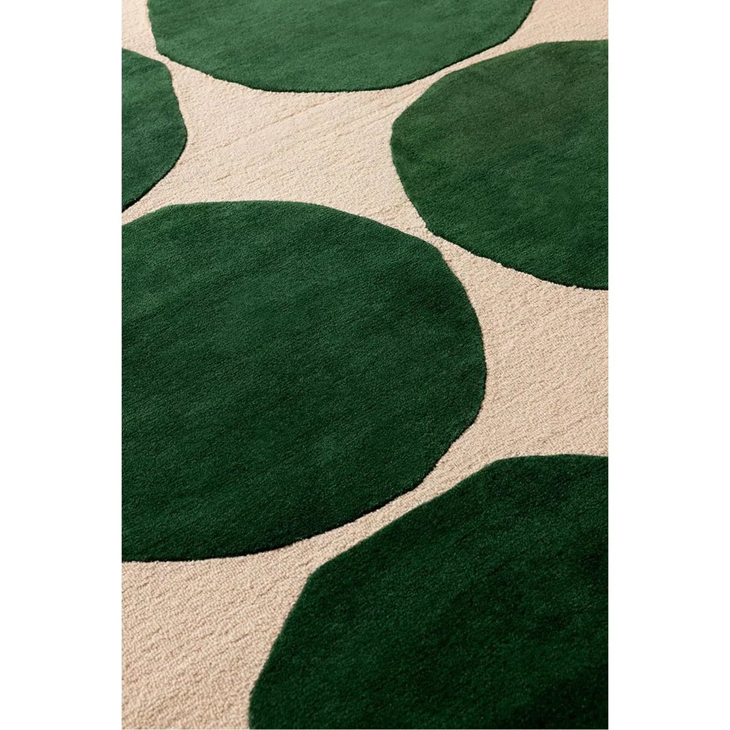 Marimekko Isot Kivet Green designer rug featuring abstract blob pattern in emerald green on beige background, hand-tufted wool