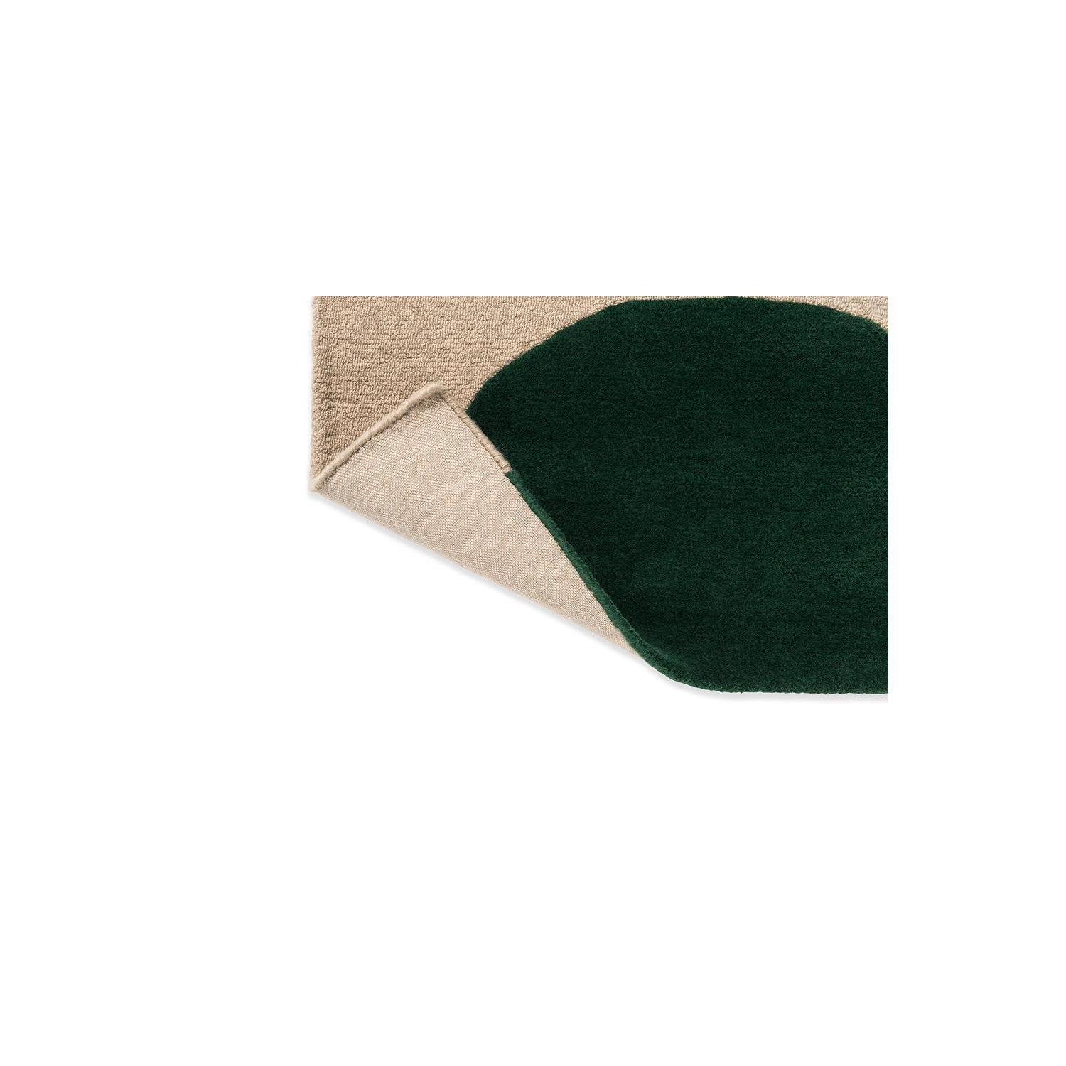 Marimekko Isot Kivet Green Rug featuring abstract pebble pattern in dark emerald green, beige and cream on light beige background, hand-tufted wool