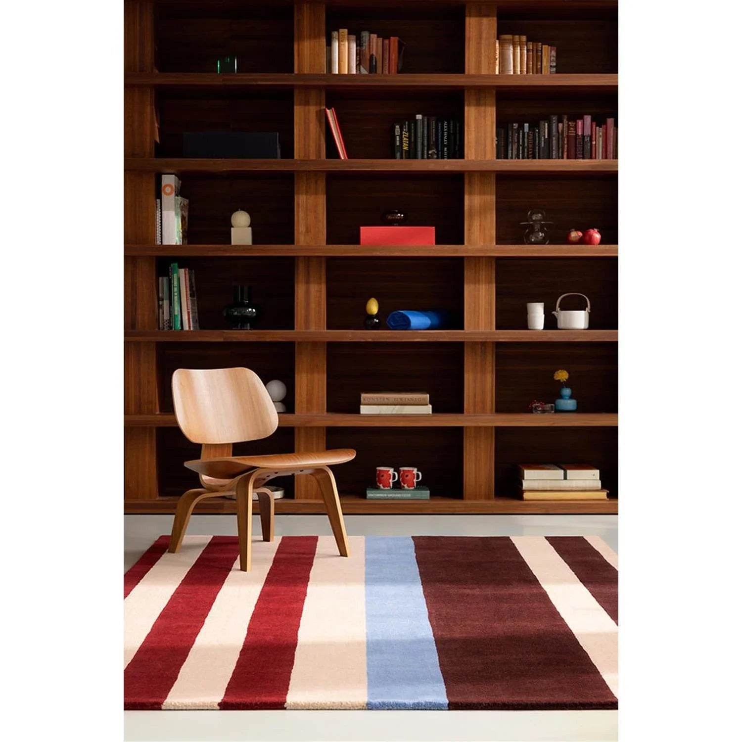 Marimekko Ralli Burnt Orange Rug featuring striped pattern in burgundy, cream, pink and blue on pale cream floor; hand-tufted wool