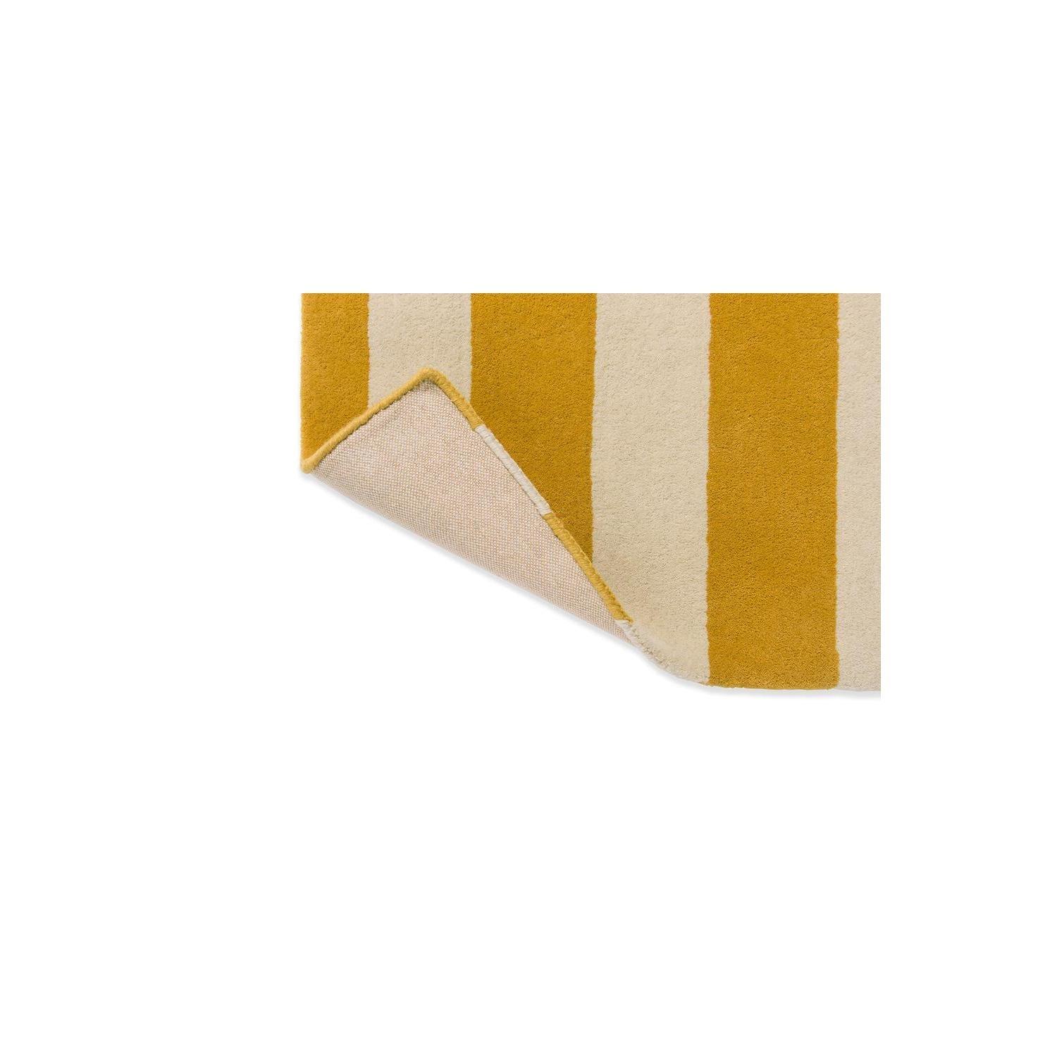 Marimekko Ralli Yellow Designer Rug featuring bold vertical stripe pattern in mustard yellow and cream on pale background, hand-tufted wool