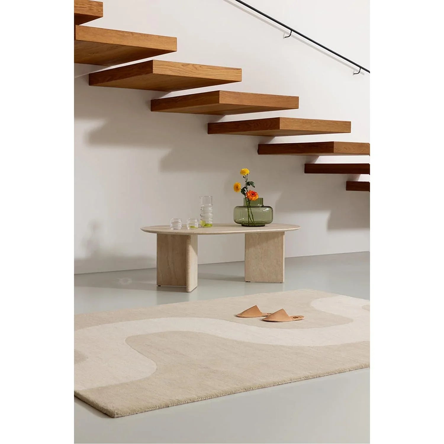 Marimekko Seireeni Warm Beige Rug featuring abstract curved pattern in beige and ivory on light beige background, hand-tufted wool
