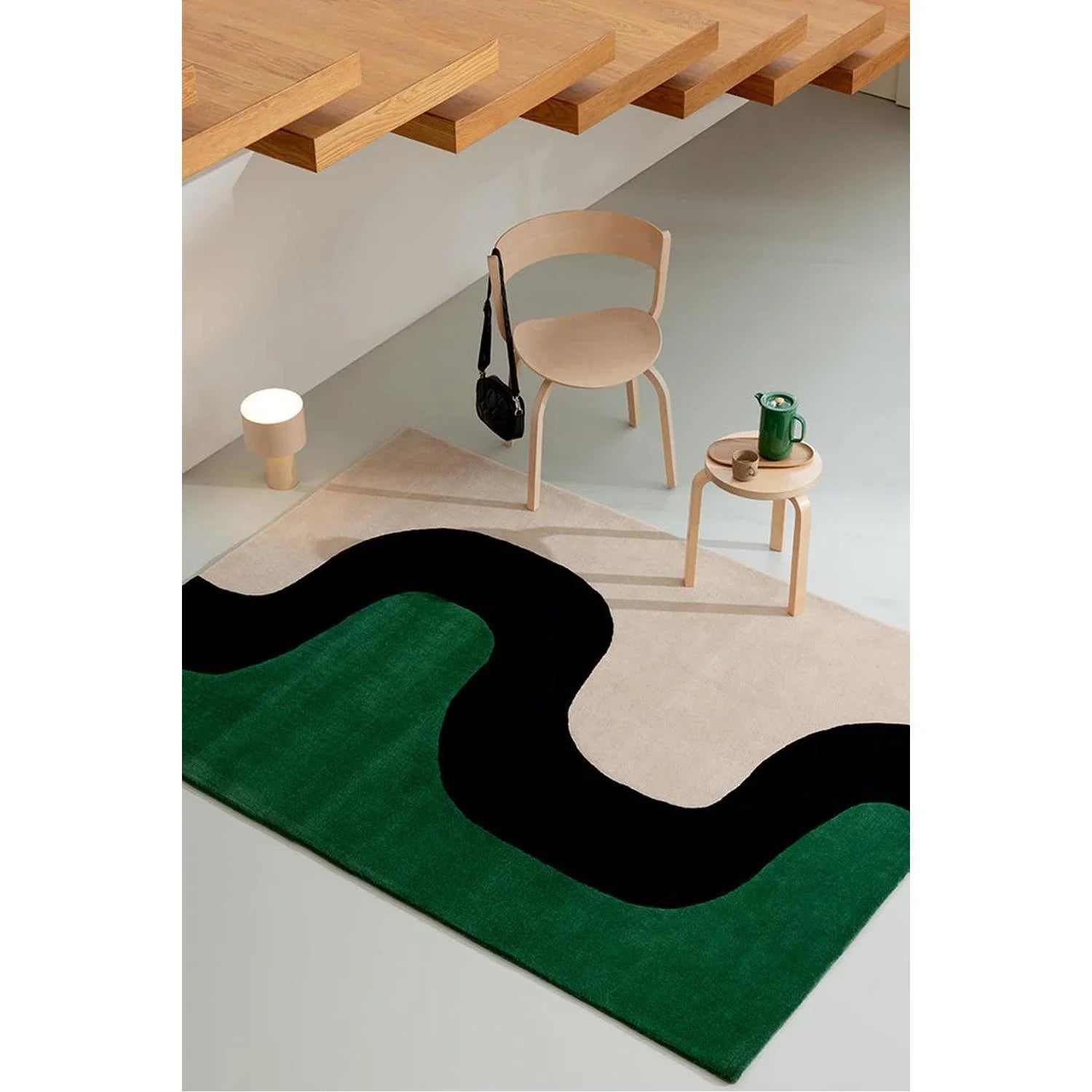 Marimekko Seireeni Green Rug featuring abstract wavy pattern in emerald green, black and cream on beige background, hand-tufted wool