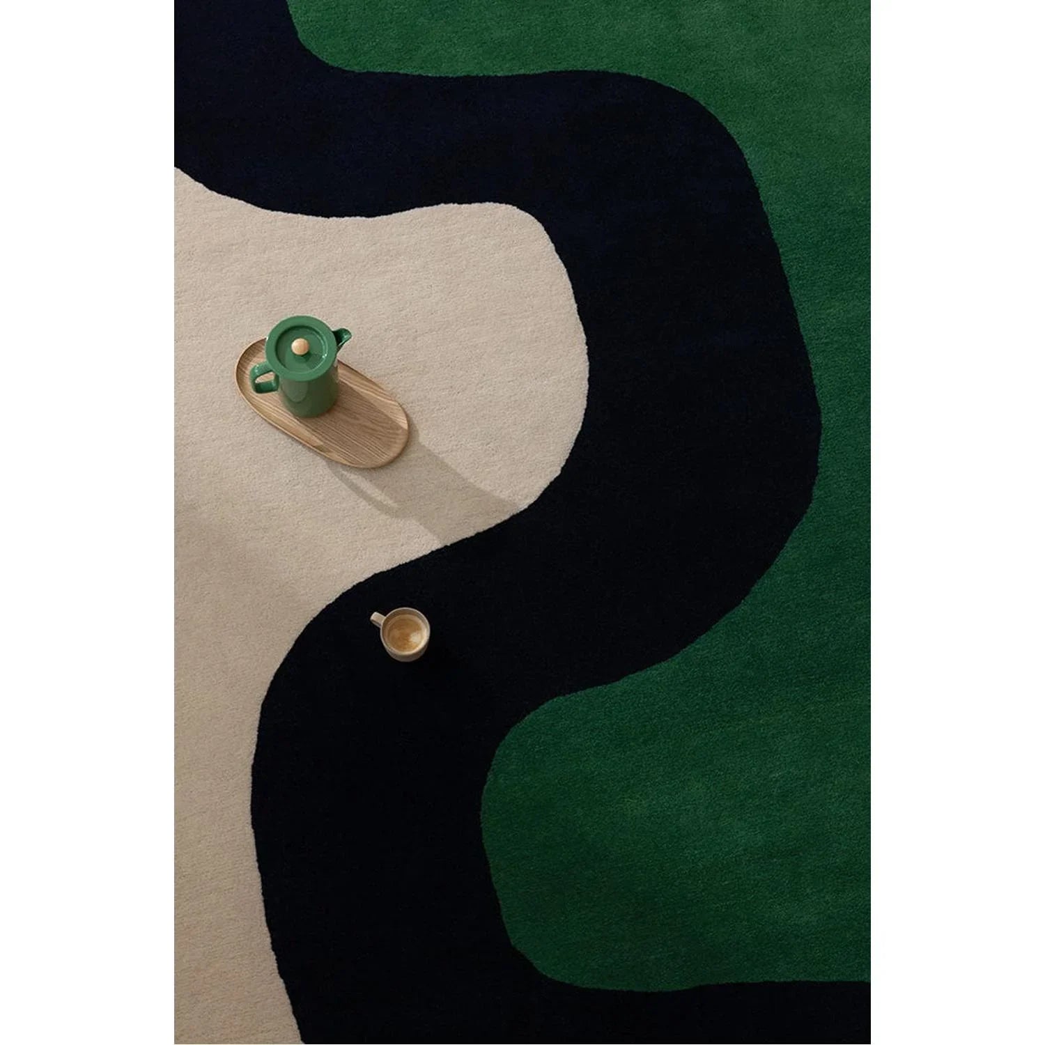 Marimekko Seireeni Green rug featuring abstract curved pattern in dark green, black and beige on cream background, hand-tufted wool