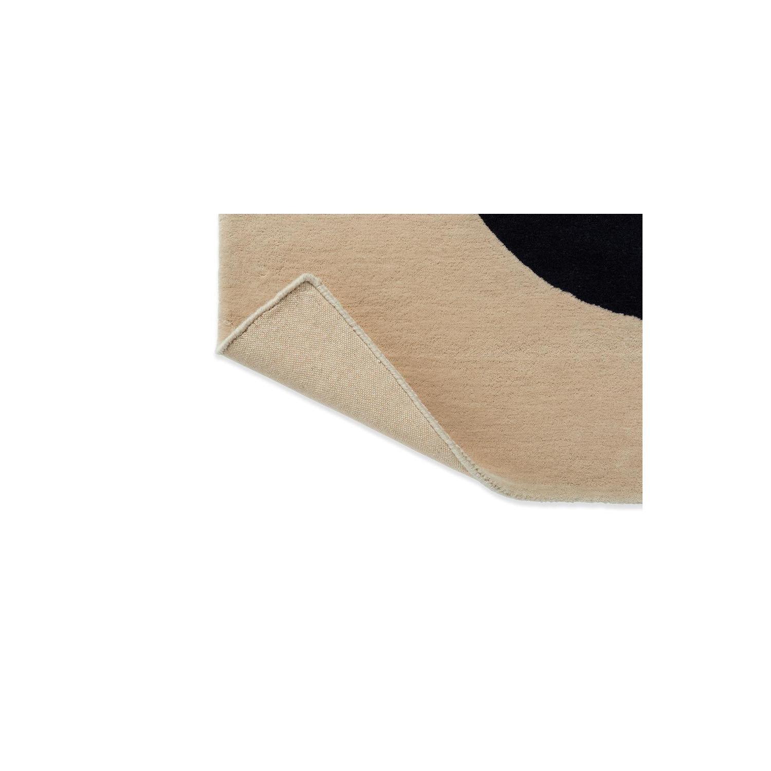 Marimekko Seireeni Green Designer Rug featuring abstract curved pattern in beige, cream and black on tan background, machine-woven BRINK & CAMPMAN rug