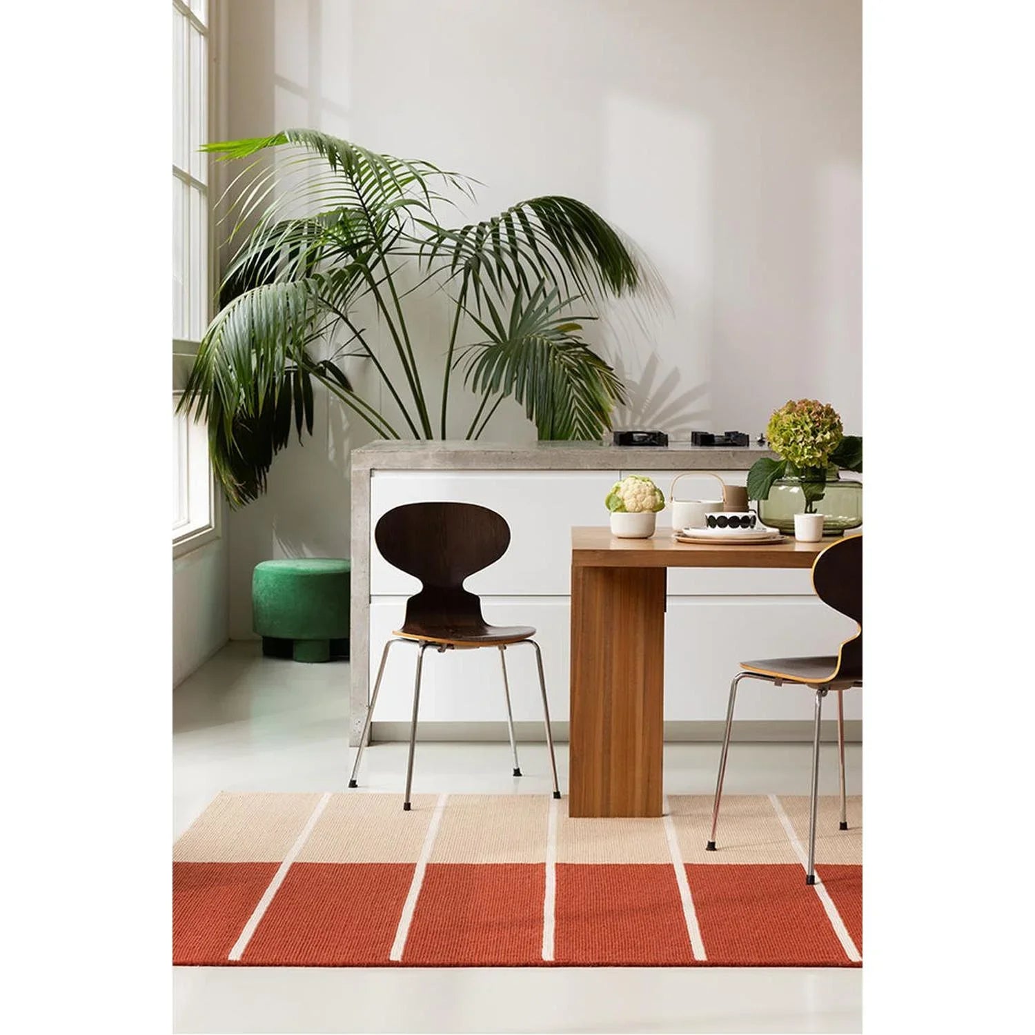 Marimekko Tiibet Burnt Orange designer rug featuring bold striped pattern in burnt orange, cream on pale beige background, machine-woven wool